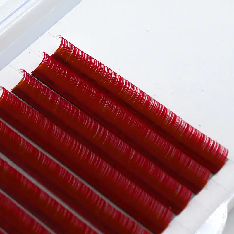 Striking red colored eyelash extensions from SinoLash Factory, presented in a neat arrangement.